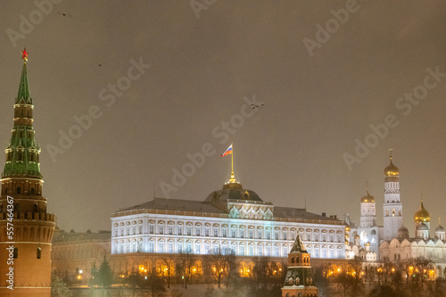 Moscow, Russia - December 27, 2022: Tower of the Moscow Kremlin. Cold and deserted Moscow street on a snowy winter evening near Red Square