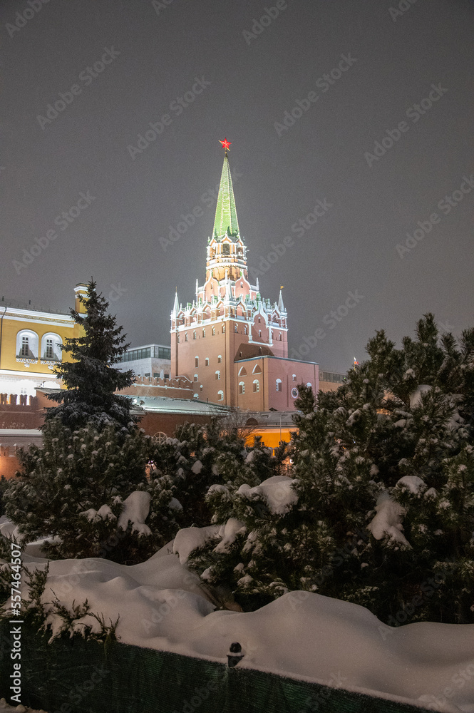 Moscow, Russia - December 27, 2022: Tower of the Moscow Kremlin. Cold and deserted Moscow street on a snowy winter evening near Red Square
