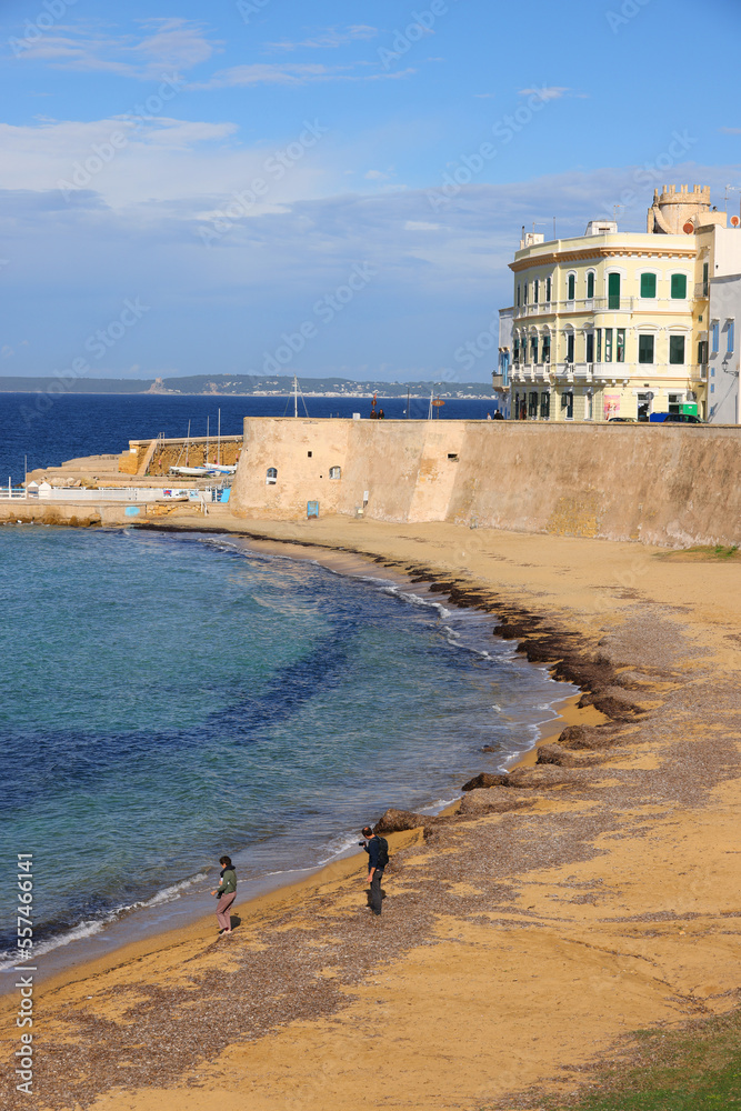Waterfront and sandy beach at sunny Gallipoli, Italy and Seno della Purita bay 