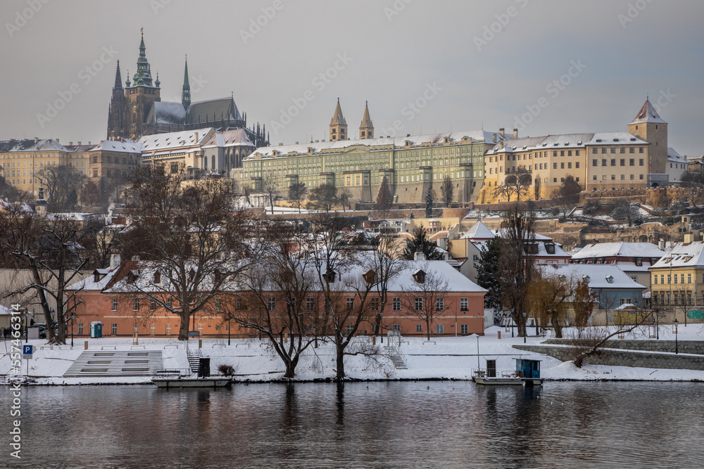 winter view of the river and the snow-covered Prague Castle