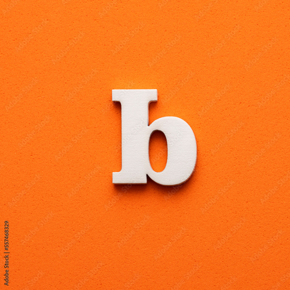 White lowercase letter b on orange foamy background