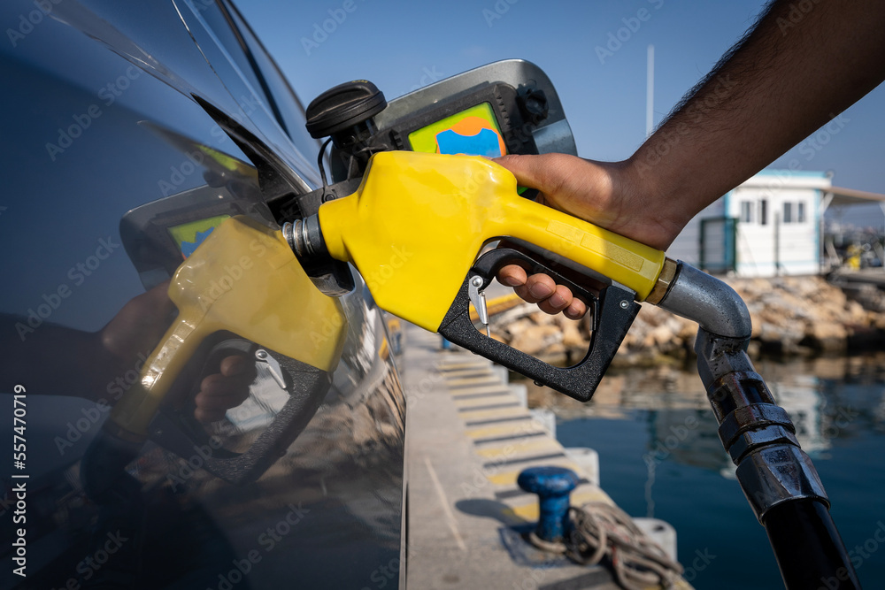 Man hand filling car with petrol pump Man hand filling car with petrol pump