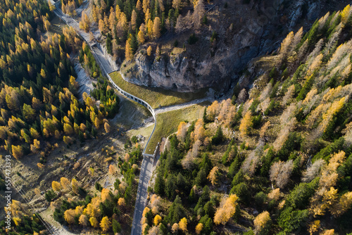 Aerial view of an avalanche protection barrier on a mountain road in the Dolomites in autumn