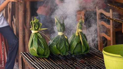typical food of the jungle. charcoal grilled meat inside banana leaves