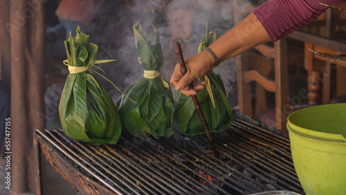typical food of the jungle. charcoal grilled meat inside banana leaves