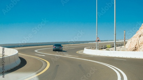 beautiful curved road view with blue sky and BMW