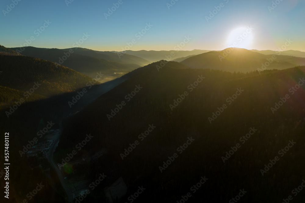 Morning sunrise over mountains and forest. Morning light fog. View from above.