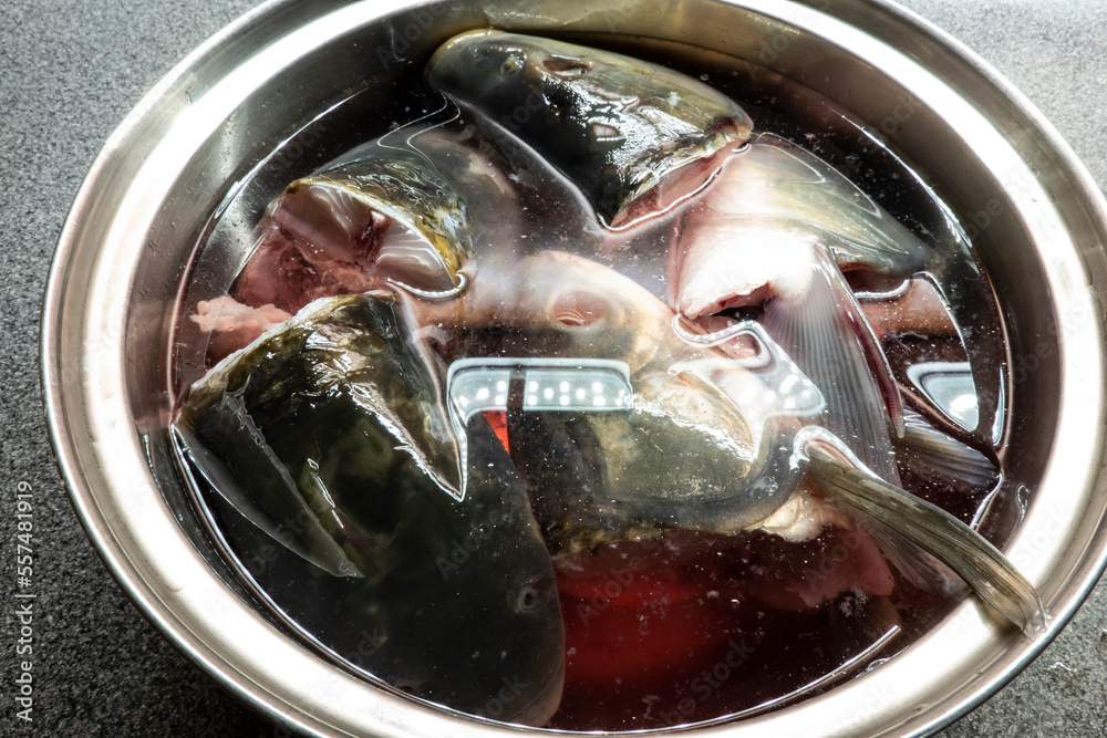 Fish heads in a pot ready to cook fish soup