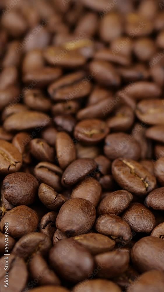Vertical screen: Roasted vietnamese coffee bean. Fragrant coffee beans scrolls slowly around the camera. Slow Motion Close Up of Whole Roasted Coffee Beans.High angle view. Shot for Social Media Vertical screen: Roasted vietnamese coffee bean. Fragrant coffee beans scrolls slowly around the camera. Slow Motion Close Up of Whole Roasted Coffee Beans.High angle view. Shot for Social Media