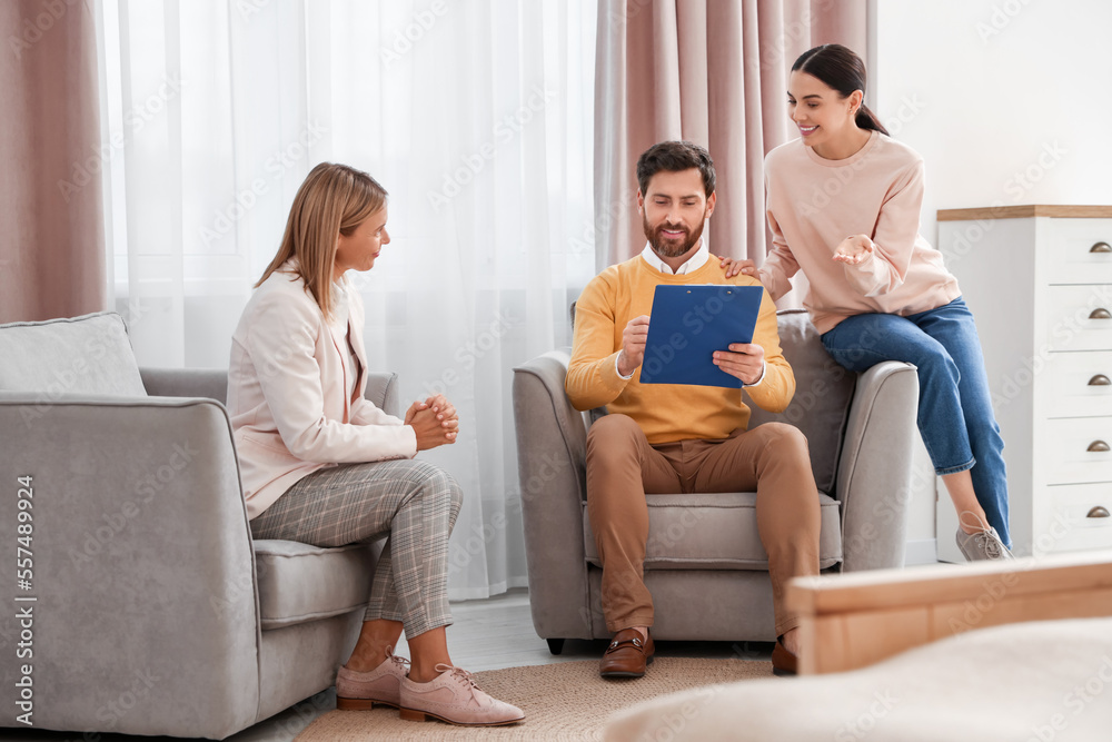 Real estate agent and couple signing contract in new apartment Real estate agent and couple signing contract in new apartment