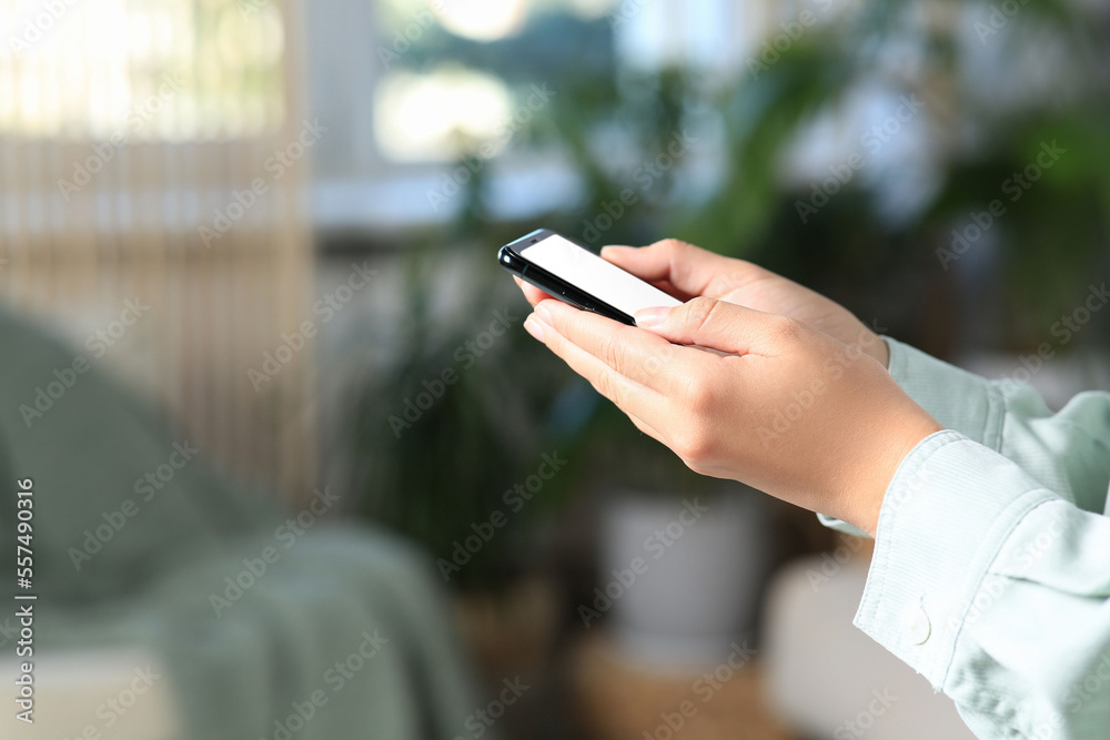 Closeup view of woman with smartphone indoors. Space for text