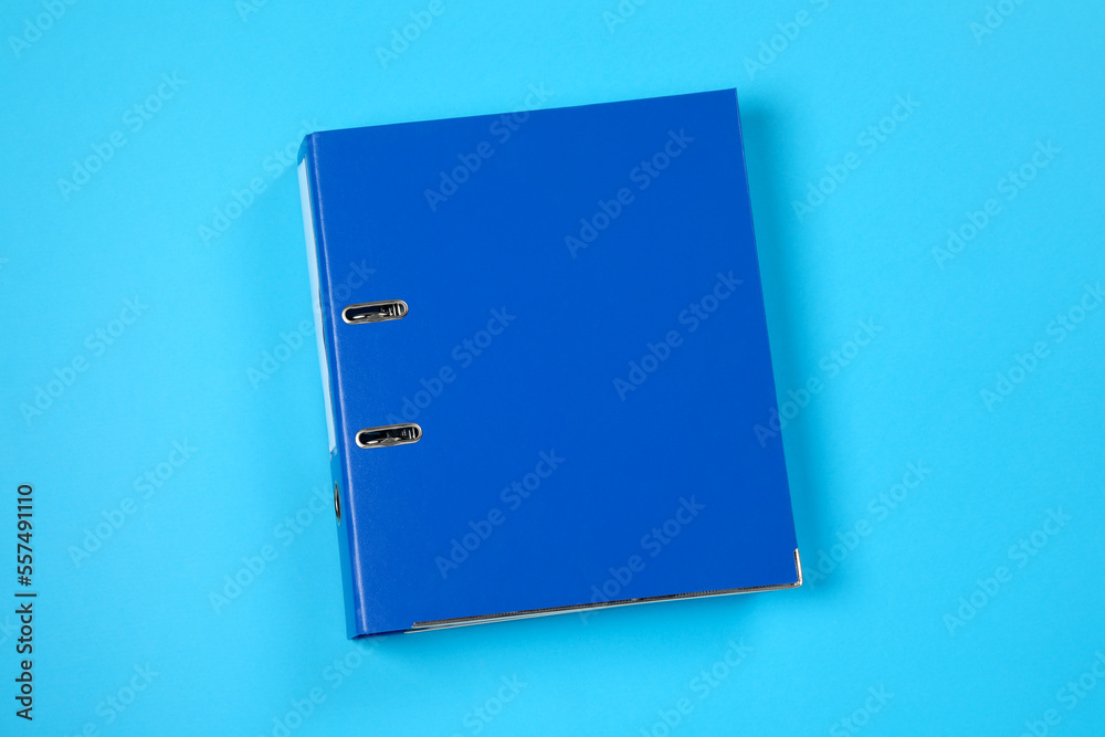 One office folder on light blue background, top view One office folder on light blue background, top view