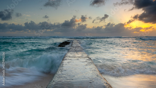 Barbados - a  perspective view of a stone pier with a colorful sunset