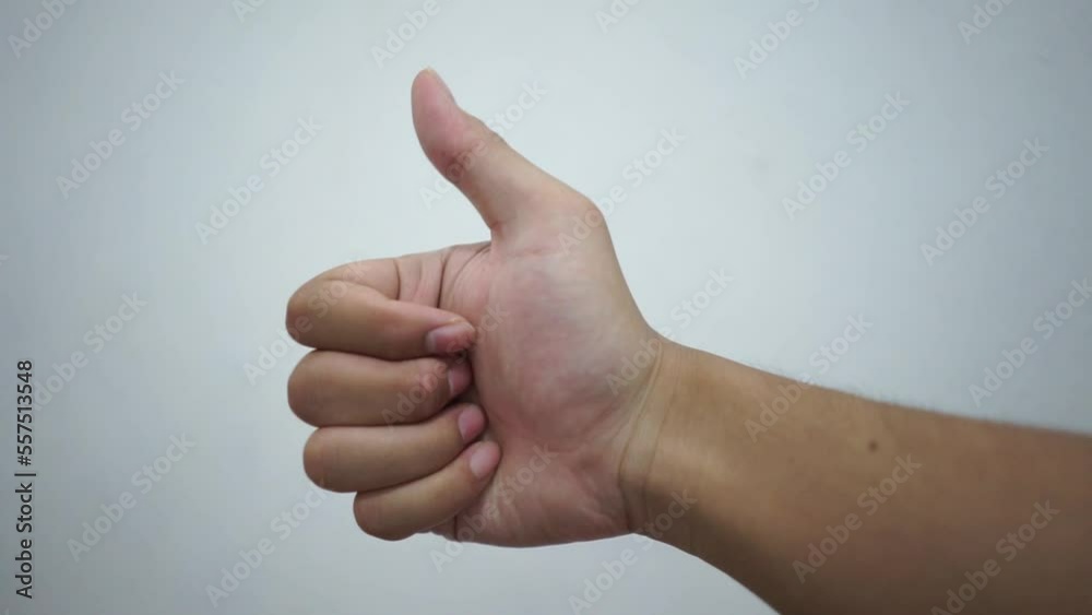 Man hand showing thumb up as a good compliment gesture in white isolated background Man hand showing thumb up as a good compliment gesture in white isolated background