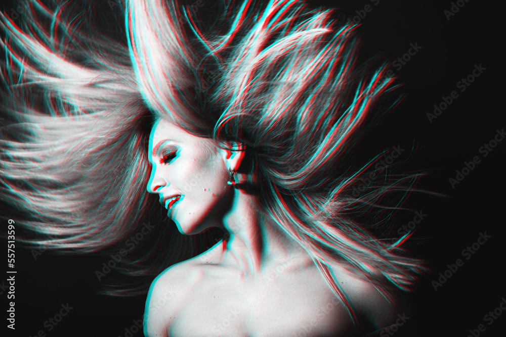 Naklejka premium Fashion concept. Portrait of beautiful woman with flying hair in red and blue color split effect style. Futuristic looking style. Image contains motion blur. Model with happy facial expression