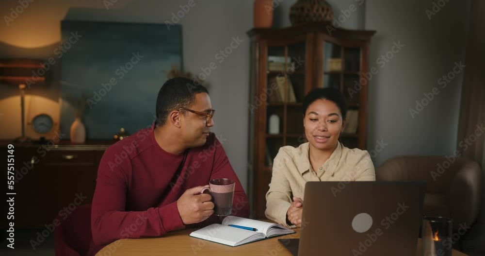 Latin man and woman sit together and talk about project Latin man and woman sit together and talk about project