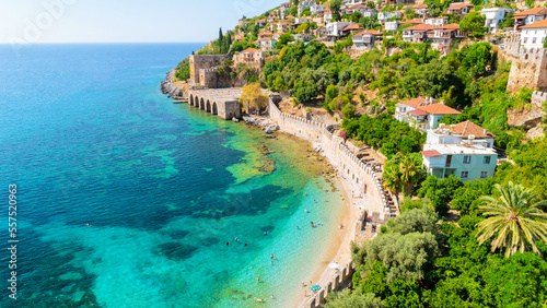 Fototapeta Naklejka Na Ścianę i Meble -  Alanya, Antalya district, Turkey shipyard from Kizil Kule tower in Alanya peninsula with turqouse colored ocean and people on the beach