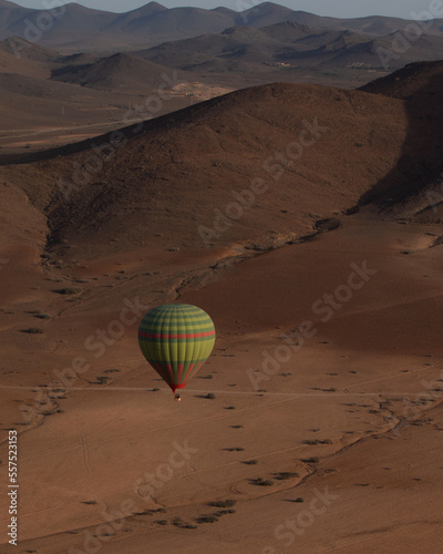 hot air ballon flying over the stone desert in Marrakesh