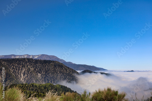 Beautiful view of the San Bernardino Mountains peaking above the clouds from the Rim of the World HWY (HWY 18) area early in the morning. Southern California, USA.