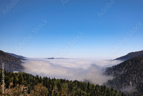 Magnificent view of the San Bernardino Mountains peaking above the clouds from the Rim of the World HWY (HWY 18) look out area early in the morning. Southern California, USA.
