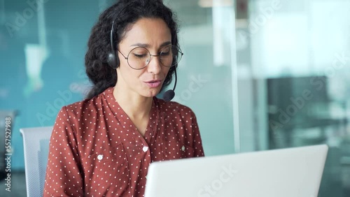 Corporate operator working in customer support service on helpline telesales Smiling woman representative call center agent in wireless headset helping client with complaints using computer in office