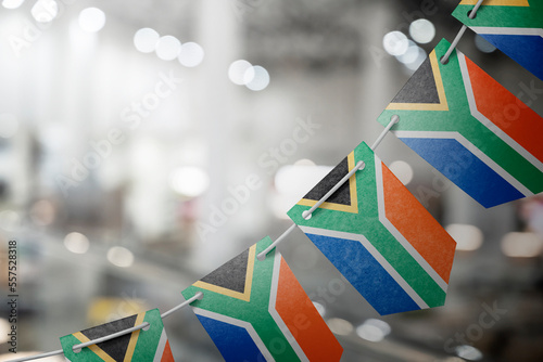 A garland of South Africa national flags on an abstract blurred background