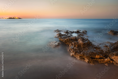Sunset and rock on the sea in Crete Greece  Hersonissos