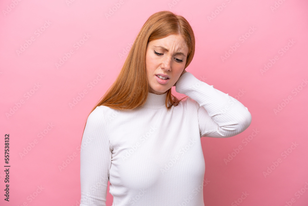 Young redhead woman isolated on pink background with neckache Young redhead woman isolated on pink background with neckache