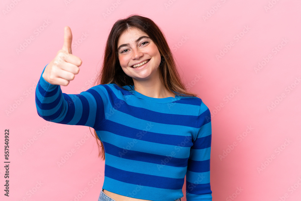 Young caucasian woman isolated on pink background with thumbs up because something good has happened Young caucasian woman isolated on pink background with thumbs up because something good has happened