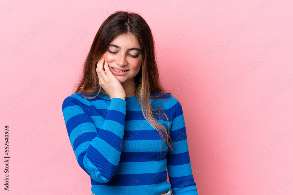 Young caucasian woman isolated on pink background with toothache