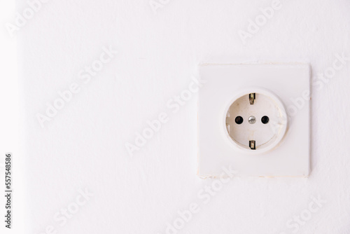Power socket on the empty white wall