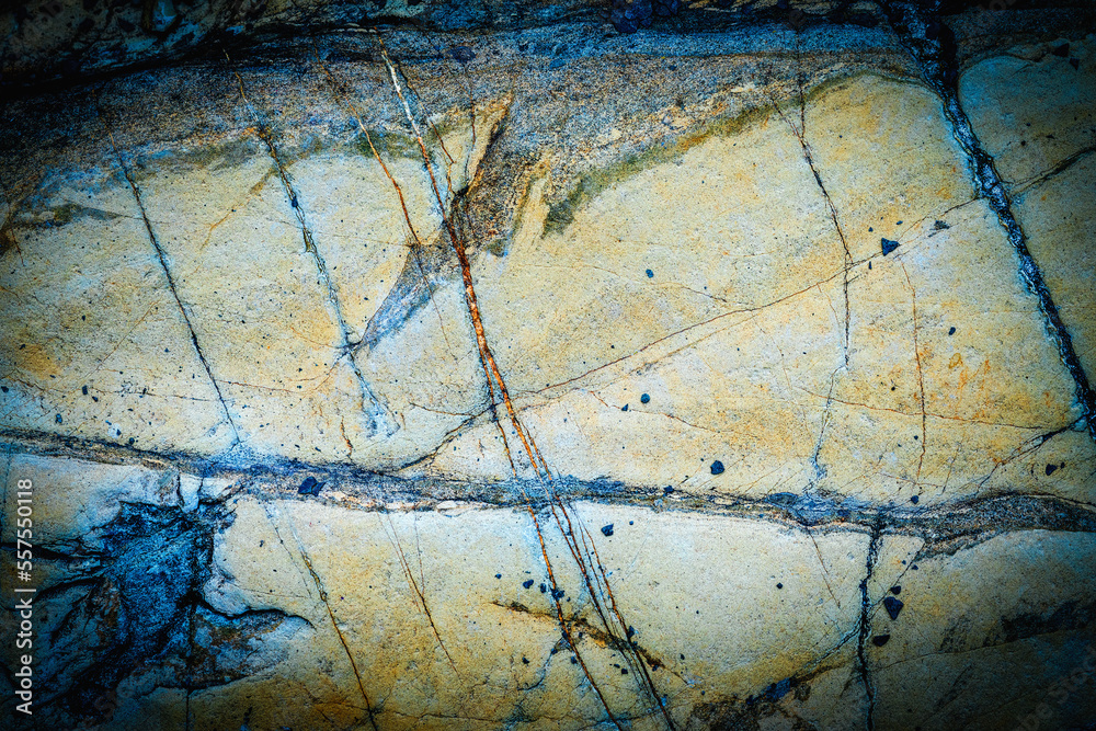 Yellow blue cracked stone wall background. Copy space for design.