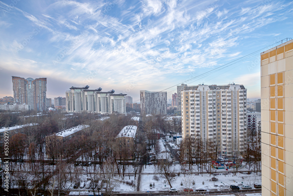 Residential area of Moscow on winter evening, against a beautiful sky with clouds, Russia