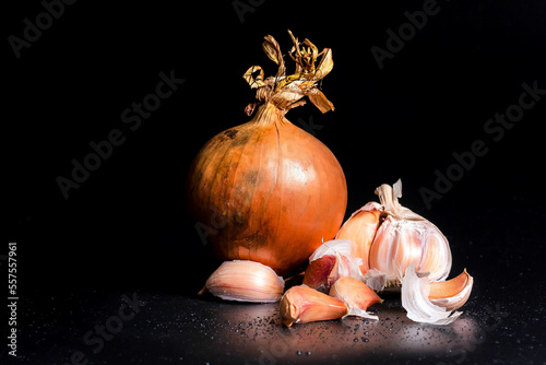 Organic garlic whole and cloves on the black background. close up images with water.