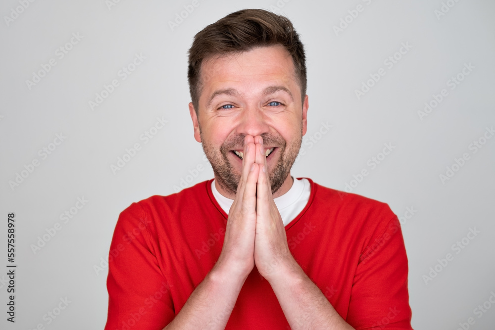 Amazed excited man does not believe his success, keeps hands near mouth Amazed excited man does not believe his success, keeps hands near mouth