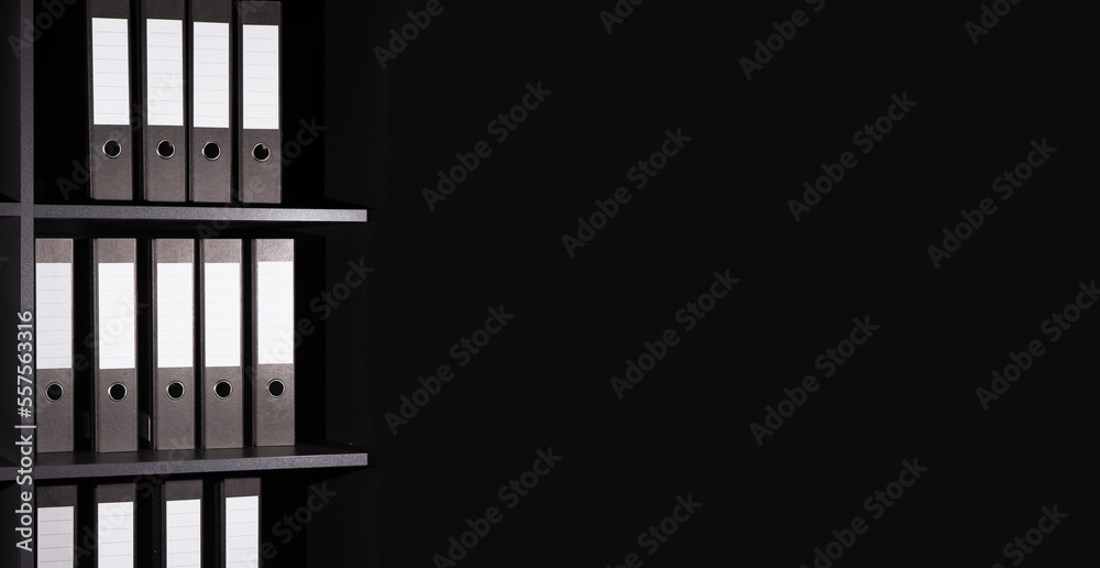 Business black banner with folders binders on shelf. Background with copy space for text Business black banner with folders binders on shelf. Background with copy space for text