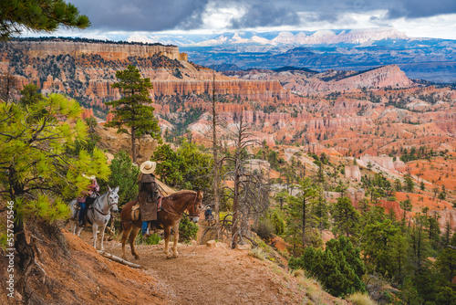 cowboy standing with his horse in bryce canyon