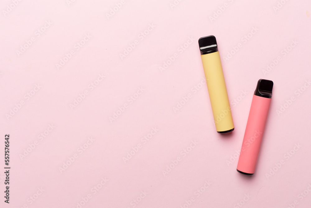 Disposable electronic cigarettes on color background, top view Disposable electronic cigarettes on color background, top view