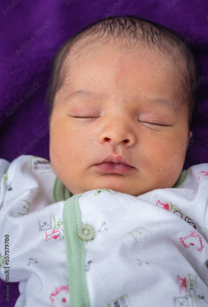 newborn baby isolated sleeping in white cloth with purple background from different angle newborn baby isolated sleeping in white cloth with purple background from different angle