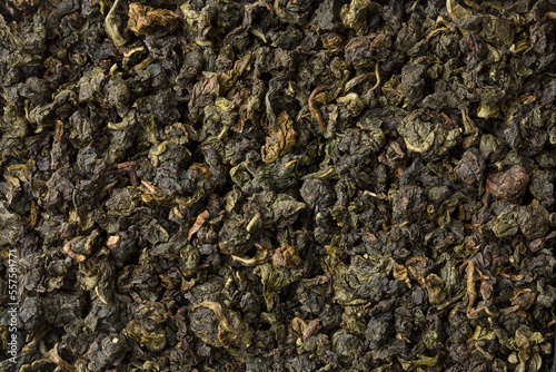 Chinese Ti Kuan Yin dried tea leaves full frame close up as background