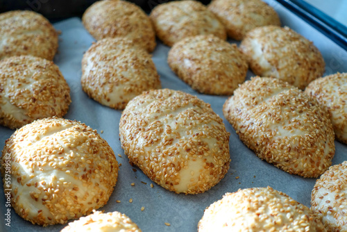 sesame seeds on raw pastry dough, ready-to-bake pastry dough lined up on the tray,