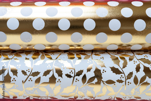 two gold foil scrapbook paper objects (dots and holly)