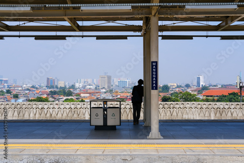 person on train platform, person on the train station, Manggarai Station Jakarta photo