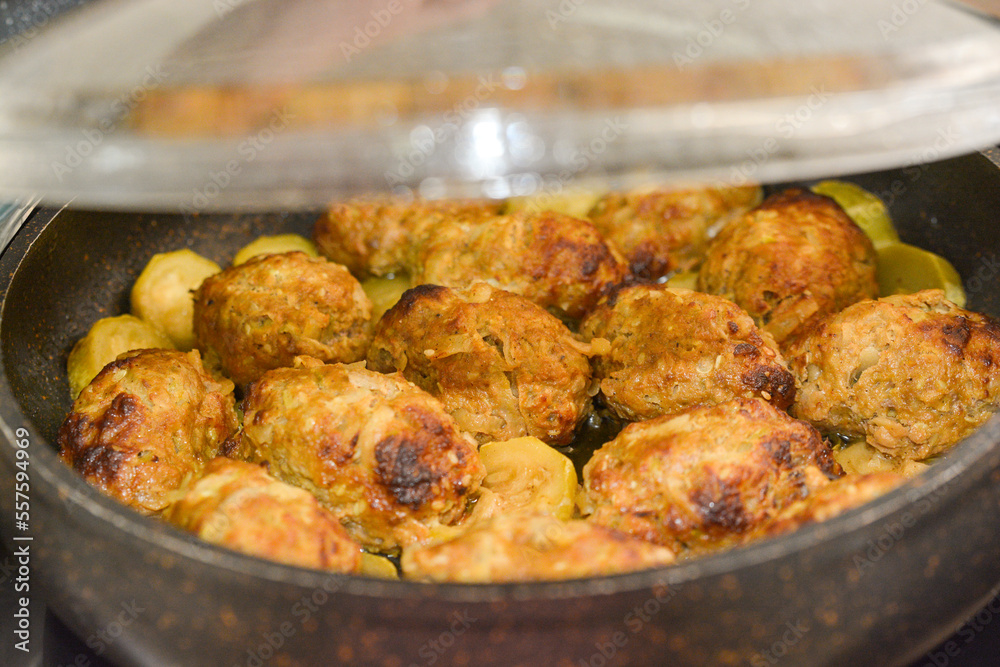 Hot stew meatball with vegetables in tomato sauce closeup in a pot on the table. Hot stew meatball with vegetables in tomato sauce closeup in a pot on the table.
