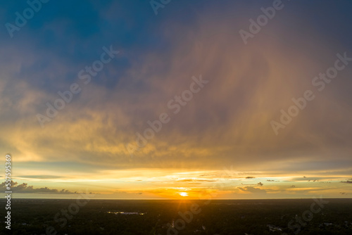 Colofrul clouds brightly illuninated by setting sun on evening sky. Changing cloudscape weather at sunset photo