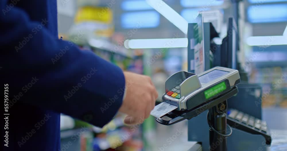 cashless payment in supermarket, man at check-desk , closeup view of hands with card, 4K, Prores cashless payment in supermarket, man at check-desk , closeup view of hands with card, 4K, Prores