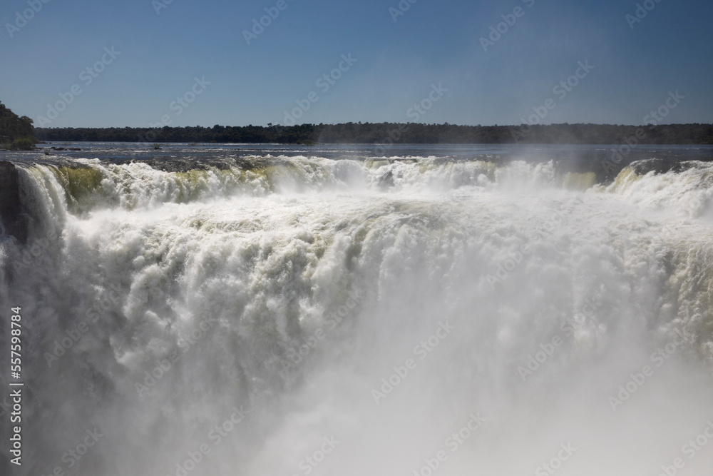 Nature's power. View of the Iguazu waterfalls and river, seen from Garganta del Diablo, in Misiones, Argentina. The amazing falls and falling white water beautiful texture, mist and splash.