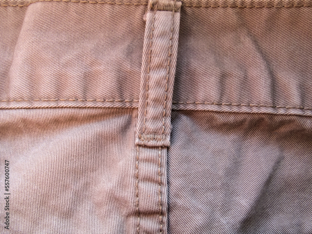 Fragment of light-colored jeans Fragment of light-colored jeans