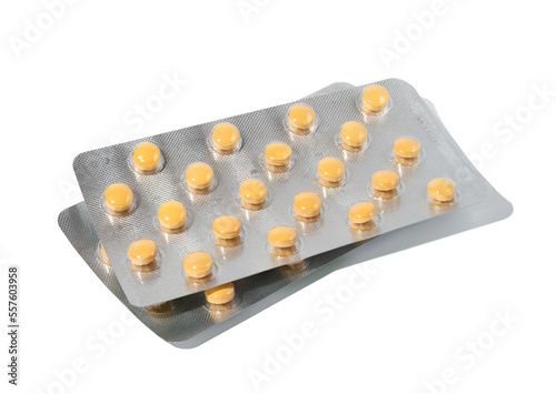 Orange round pills in blister pack on a white background