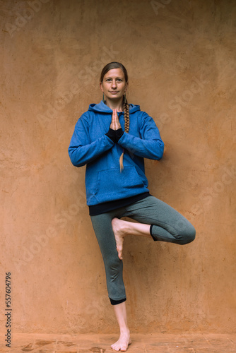 A single woman standing practicing yoga and meditation. Healthy lifestyle.